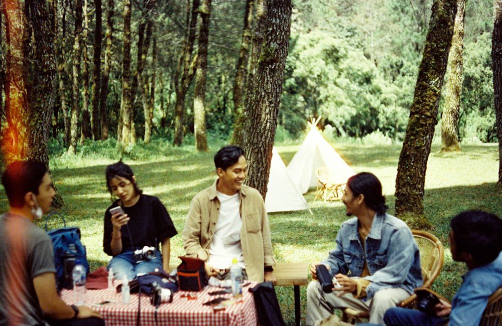 college students having a picnic with a teepee