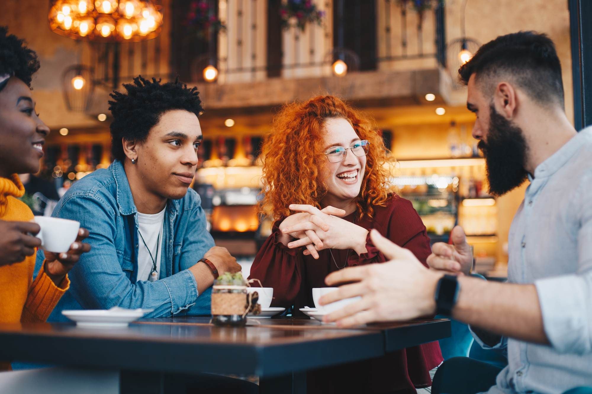 Friends enjoying coffee and conversation at a cozy café near District Flats Columbia, capturing the neighborhood’s social and welcoming atmosphere.